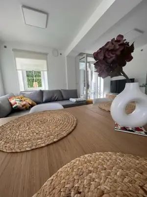 a living room with a vase on a wooden floor at Natura in Radovljica