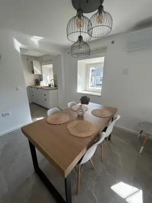 a dining room with a wooden table and chairs at Natura in Radovljica