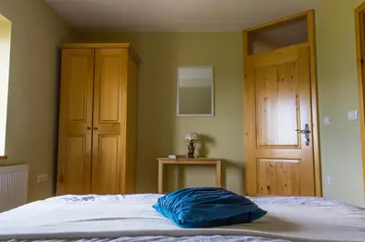 a bedroom with a bed with a blue pillow on it at Turistična Kmetija Toman in Gornji Grad