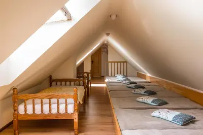 a row of beds in a attic room at Turistična Kmetija Toman in Gornji Grad