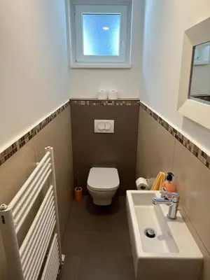 a bathroom with a toilet and a sink and a window at Apartment with balcony Hiša Brdo 48 in Bovec