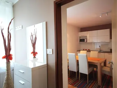 a kitchen and dining room with a table and chairs at Apartment with balcony Hiša Brdo 48 in Bovec