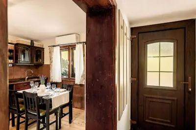 a kitchen and dining room with a table and chairs at Herbal Apartment Marjetka in Šentjur