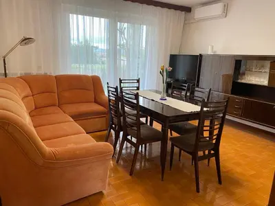 a living room with a couch and a table with chairs at Hiša Tavčar in Dutovlje