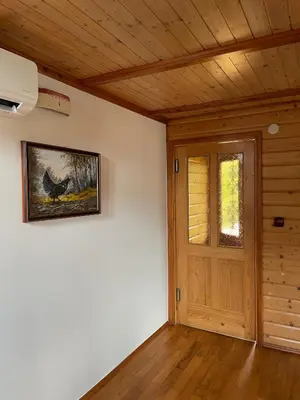 a room with a door and a picture on the wall at Sedmakovo - Počitniška hiša v naravi - Ljubno ob Savinji in Ljubno
