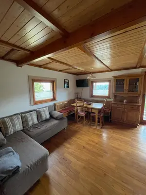 a living room with a couch and a table at Sedmakovo - Počitniška hiša v naravi - Ljubno ob Savinji in Ljubno