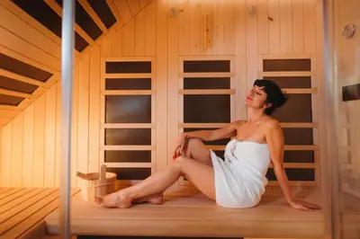 a woman sitting in the inside of a sauna at Menart Estate apartments in Cerklje na Gorenjskem