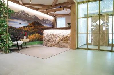 a lobby with a mural of mountains on the wall at Menart Estate apartments in Cerklje na Gorenjskem
