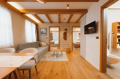 a living room with a couch and a table at Menart Estate apartments in Cerklje na Gorenjskem