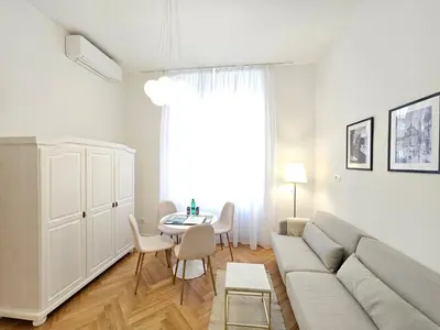 a living room with a couch and a table at Urban Nest Wolfova by the Triple Bridge in Ljubljana