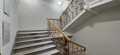 a staircase in a house with a metal railing at Urban Nest Wolfova by the Triple Bridge in Ljubljana