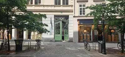 a building with a green door on a street at Urban Nest Wolfova by the Triple Bridge in Ljubljana