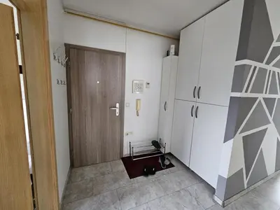 a room with a closet and a door and a refrigerator at Designer apartment in nature in Vojnik