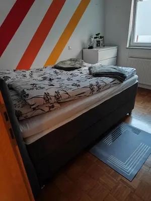 a bed sitting in a room with a bed frame at Designer apartment in nature in Vojnik