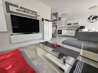 a living room with a couch and a television at Designer apartment in nature in Vojnik