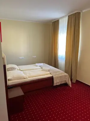 a bedroom with a large bed with a window at Prenočišča Zvezda in Ljutomer