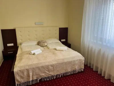 a bedroom with a bed with two towels on it at Prenočišča Zvezda in Ljutomer
