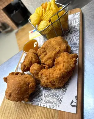 a plate of fried food and a bowl of chips at Prenočišča Zvezda in Ljutomer