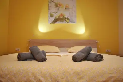 a bed with two pillows on top of it at Apartment Murka in Begunje na Gorenjskem