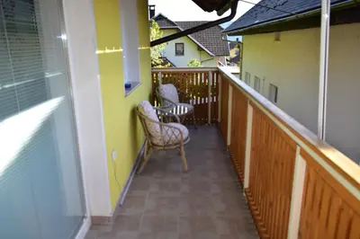 a balcony with two chairs at Apartment Murka in Begunje na Gorenjskem