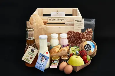 a lunch box filled with food and a box of milk at Apartment Murka in Begunje na Gorenjskem