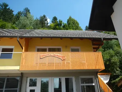 a yellow house with an orange roof at Apartment Murka in Begunje na Gorenjskem