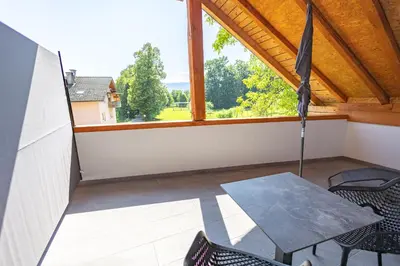 a balcony with a table and chairs and a window at Apartma Pr' Bavnč in Lesce