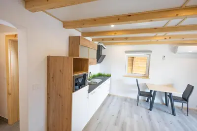 a kitchen and dining room with a table and chairs at Apartma Pr' Bavnč in Lesce