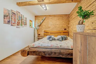 a bedroom with a bed with two elephants on it at Vineyard cottage Pri mali luži in Trebelno