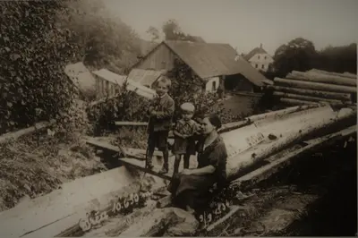 an old photo of three children standing on a bridge at Apartment Vintgar in Slovenska Bistrica