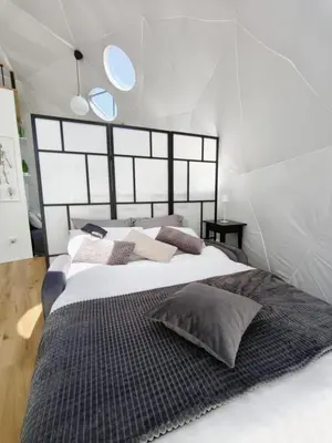 a bedroom with a large bed with pillows on it at Cozy Fizio Dome in Gradišče v Slovenskih Goricah