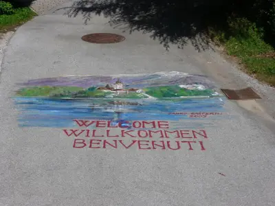 a painting on the road with a welcome to willleton bennington at Apartments Mira in Bled