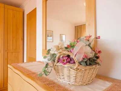 a basket of flowers sitting on top of a table at Apartments Mira in Bled