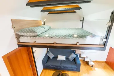 a bedroom with a bunk bed and a blue chair at Apartma Igor in Bohinj