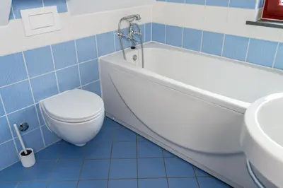 a bathroom with a toilet and a tub and a sink at Apartma Igor in Bohinj