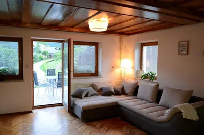 a living room with a couch and a patio at Anna's House in Bled