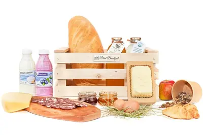a crate filled with different types of bread and food at Anna's House in Bled