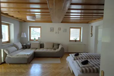 a living room with a couch and a table at Anna's House in Bled
