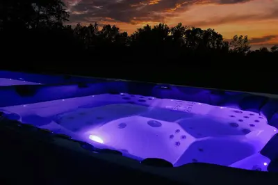 a purple bathtub with a purple light in the dark at Relax Apartma in Gornja Radgona