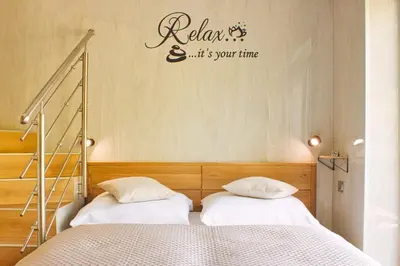 a bedroom with a bed with two pillows at Relax Apartma in Gornja Radgona