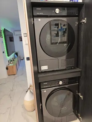 a microwave in a stand with a tv at Rozna Retreat in Nova Gorica