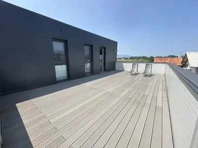 a deck with two chairs on top of a building at Apartments Lux in Spodnja Hajdina