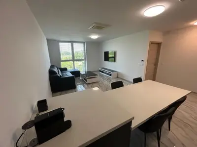 an empty living room with a table and chairs at Apartments Lux in Spodnja Hajdina