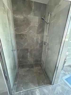 a shower with a glass door in a bathroom at Apartments Lux in Spodnja Hajdina