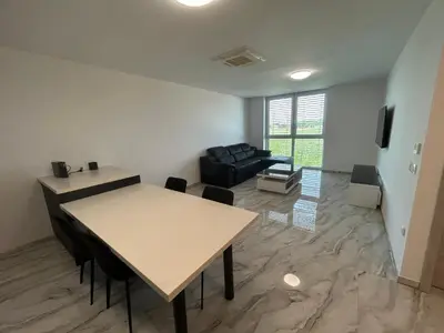 a living room with a table and a couch at Apartments Lux in Spodnja Hajdina