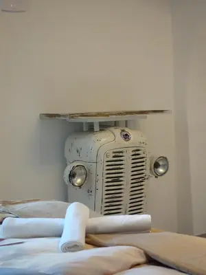 an old radiator sitting on the corner of a room at Apartmaji Pri fijakarju - Apartments 
