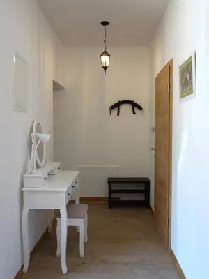 a room with a white desk and a door at Apartmaji Pri fijakarju - Apartments 