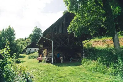 a group of people standing outside of a barn at Nature-based Retreat by Naj Raste in Senovo