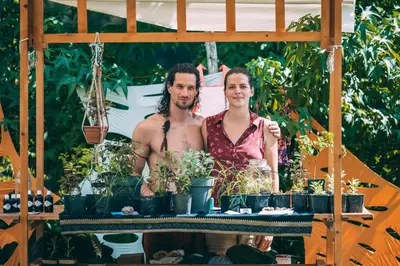 a man and a woman standing next to potted plants at Nature-based Retreat by Naj Raste in Senovo