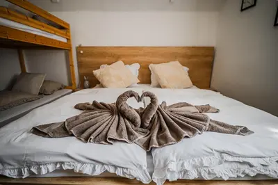 a bed with two towels in the shape of hearts at Apartment Marni w/ Parking | Kranjska Gora in Kranjska Gora